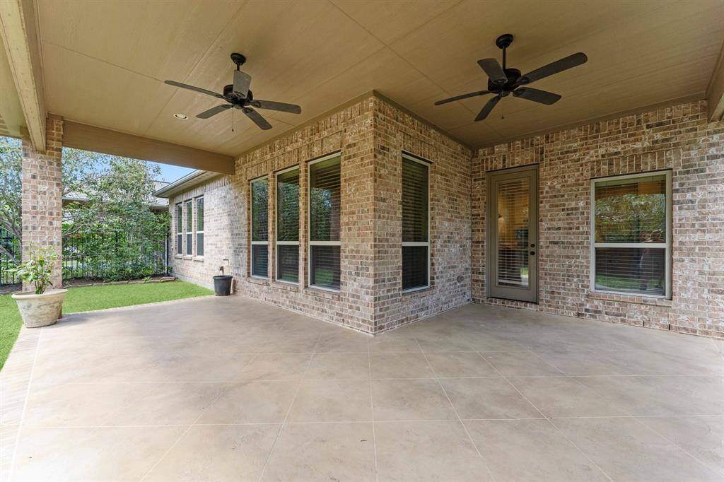 Spacious 400+ sqft covered patio featuring elegant custom tile.