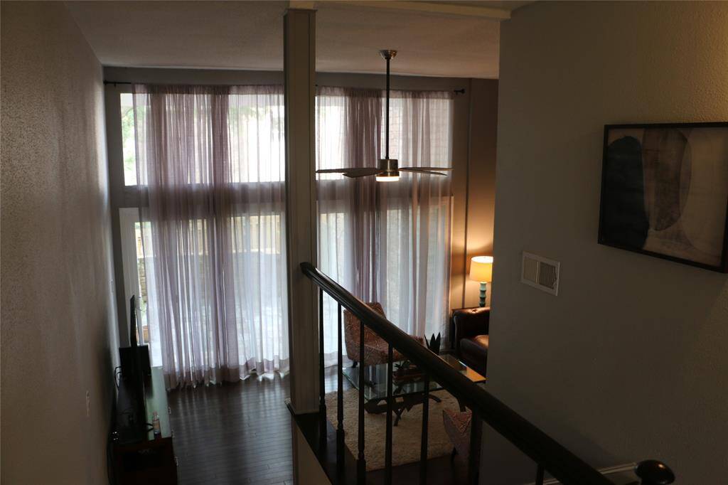 Drapery hangs in living room with the option of drawing back or keeping in tact for privacy