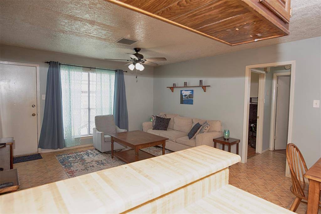 A view of the kitchen breakfast bar to the family room.