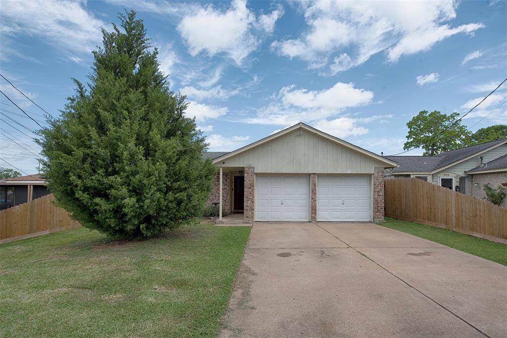 A street view of the home. Gorgeous tree in the front yard will provide great fun decorating during the holidays.