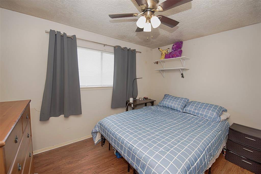 Secondary bedroom with gorgeous wood laminate floors and room for a king bed.