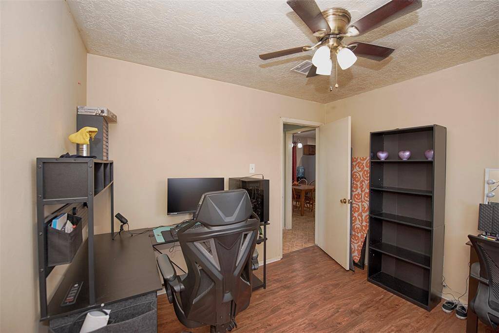 Another view of the bedroom which has the gorgeous laminate wood floors.