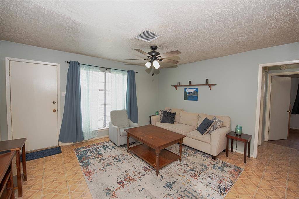 As you approach the kitchen a view of the family room with access to the door to the backyard.