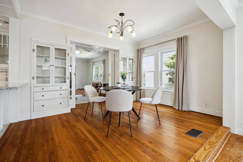 Light-filled dining space with seamless access to the kitchen and a fireplace framed by built-ins—designed for everyday ease and warm gatherings.