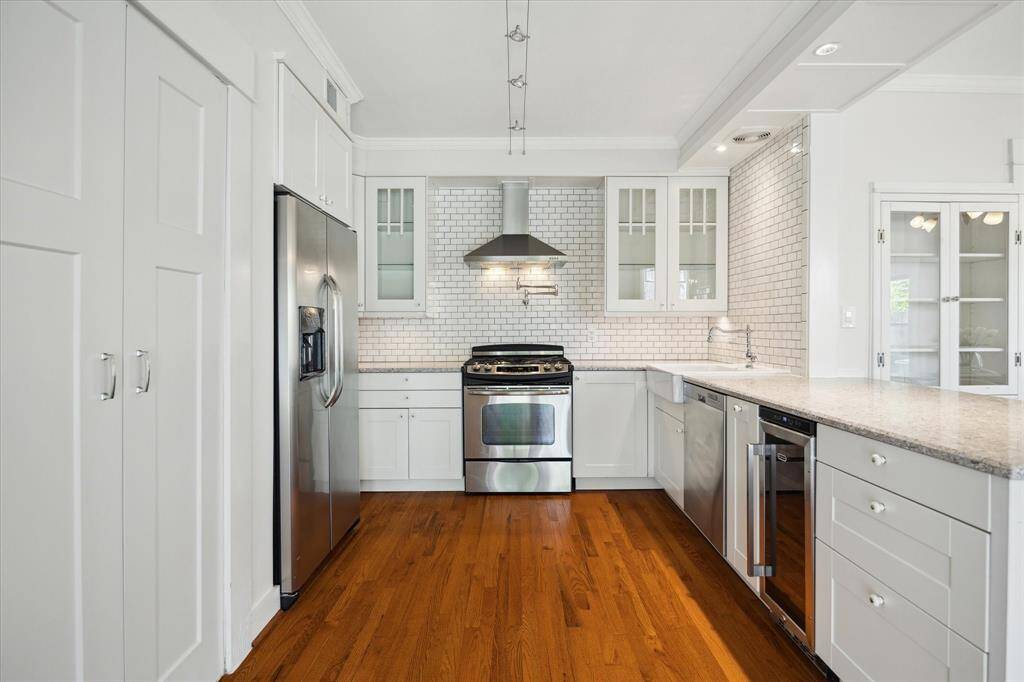 A kitchen with all the needs of a modern homeowner, stainless appliances, and extensive cabinetry. A functional hub for cooking and gathering.