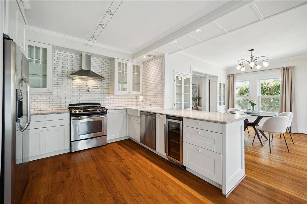 Well-organized kitchen with generous storage, workspace, and room for bar seating. Positioned for connection to the rest of the home.