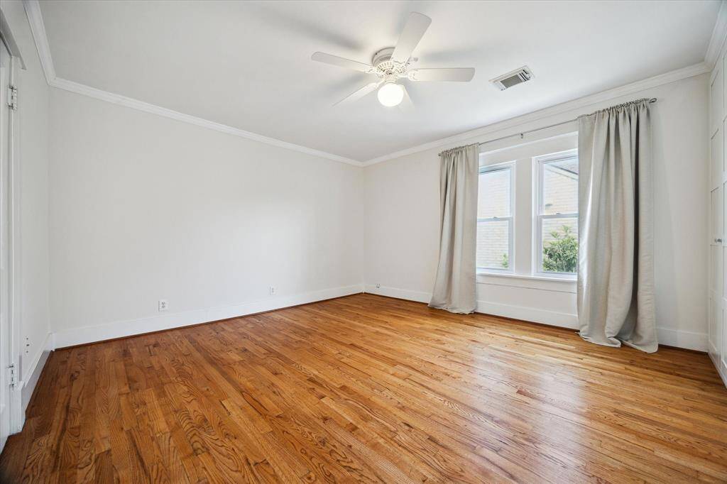 This primary bedroom with double windows and space for flexible layout options. Calm and bright with classic hardwood floors throughout.