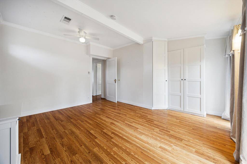 Spacious upstairs bedroom with natural light and a full closet. A peaceful retreat with room to stretch out or set up a workspace.
