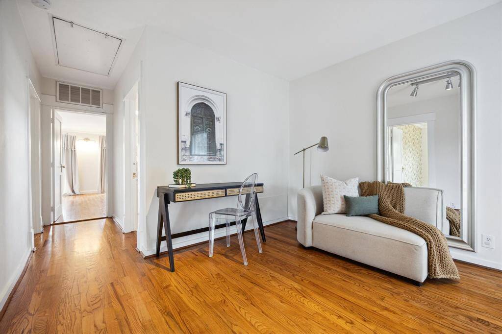 Flexible space on the upper level with a full wall of storage and built-in lighting. Ideal for working from home, creative projects, or relaxing and reading.