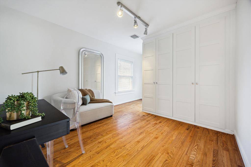 This quiet upper-level room receives great natural light and includes built-in storage across one wall. Offers privacy and flexibility for various uses.