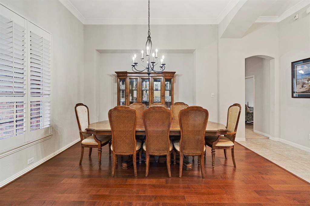 Dine in style in the formal dining room, highlighted by an elegant 8-light modern candelabra chandelier.