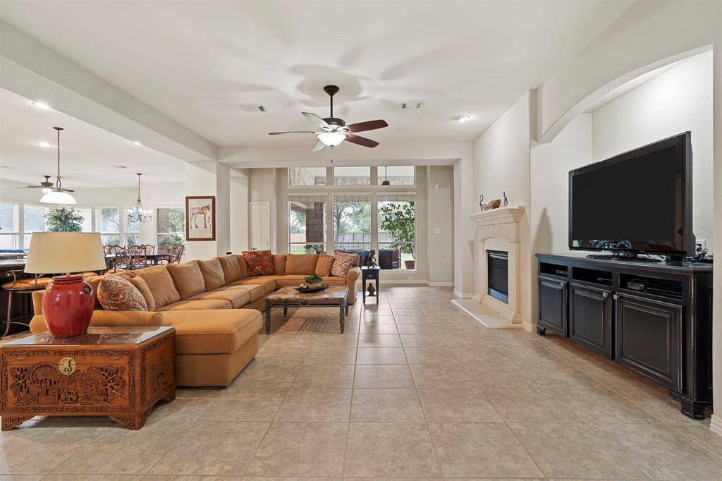 The spacious family room opens to the kitchen and breakfast area and features a cozy gas-log fireplace and a built-in wall niche perfect for your TV.