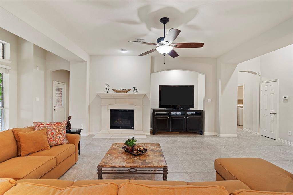 The archway on the left leads to the guest bath and back patio, while the one on the right leads to the primary suite.
