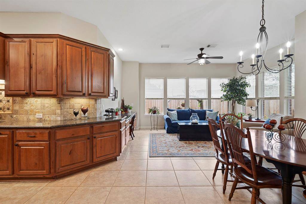 The kitchen, breakfast area, and sunroom flow seamlessly together, creating a bright and connected space that's perfect for everyday living and casual gatherings.