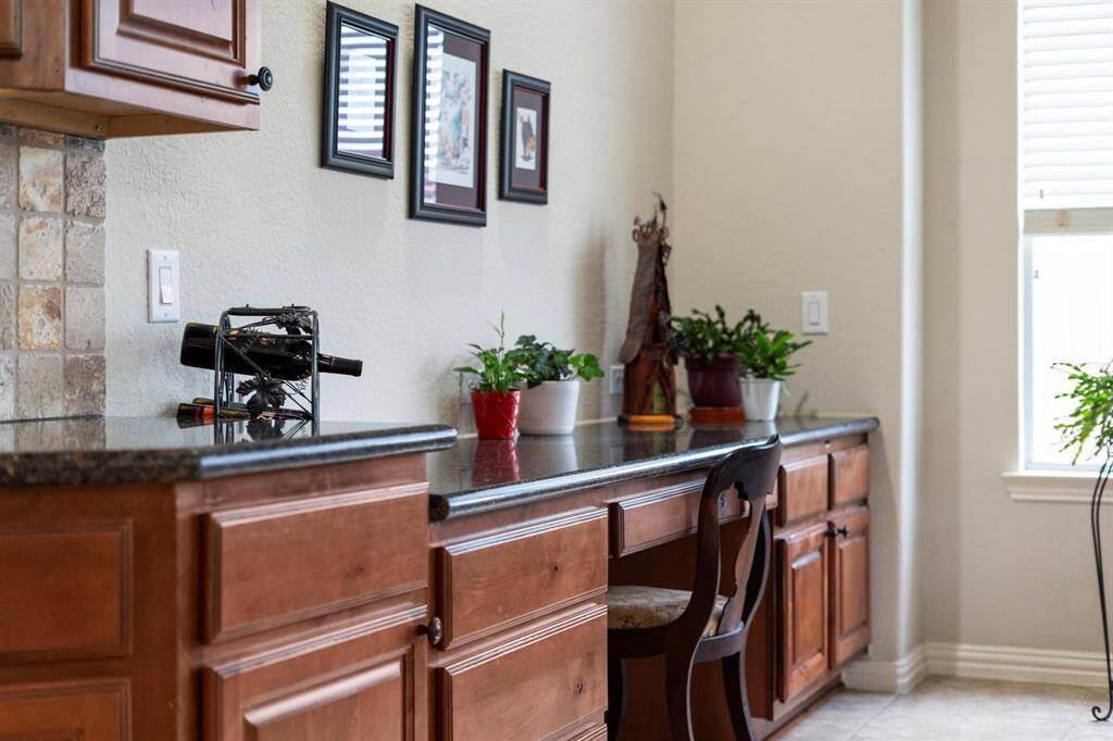 With a built-in desk, drawers, storage cabinets, and expansive counter space, this area is perfect for homework or as a second office.