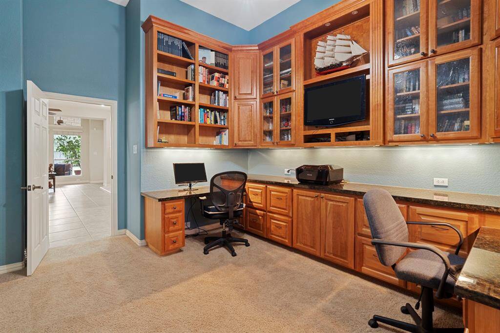 The dedicated home office features built-in workstations, bookshelves, and abundant storage.