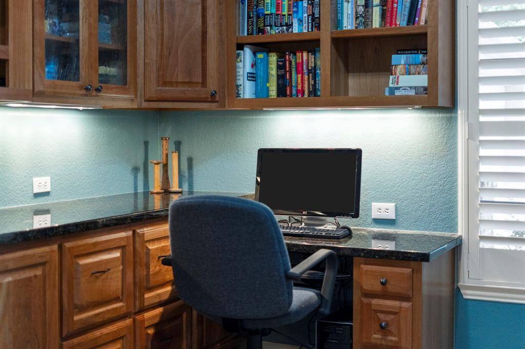 The under-cabinet desk lighting in the office adds both functionality and a warm, inviting glow, ideal for late-night work or focused tasks.