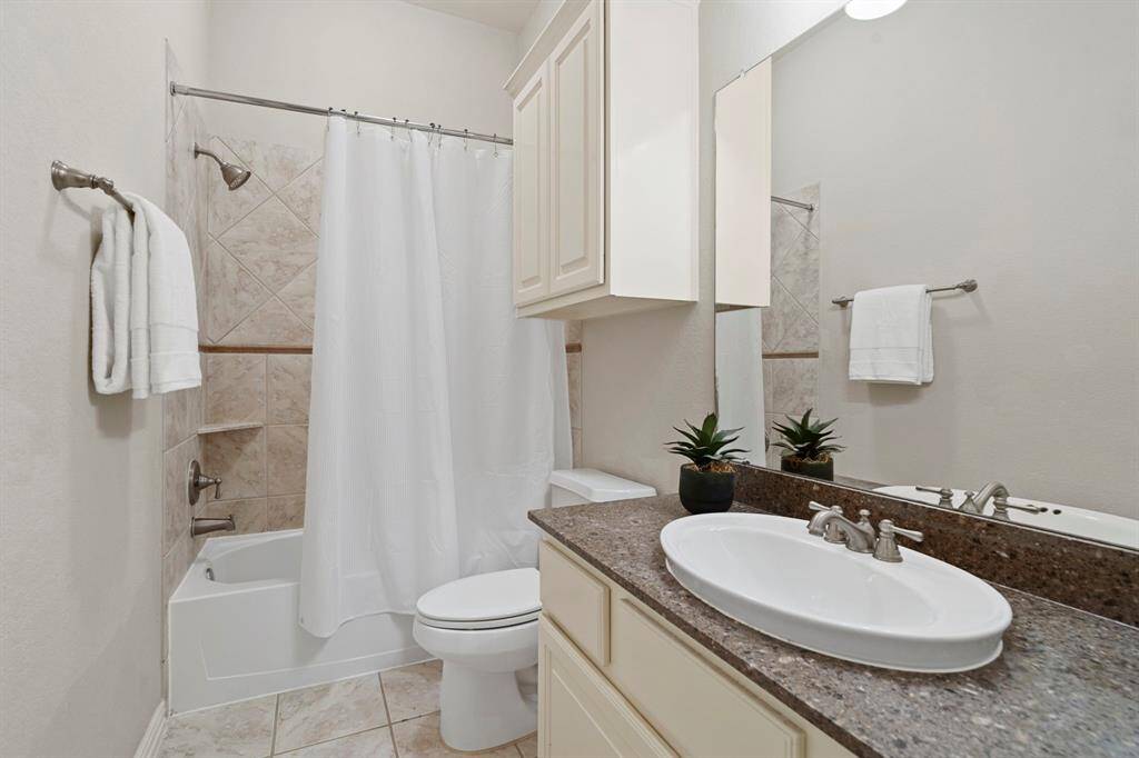 This full bathroom is accessible from both the game room and one of the secondary bedrooms.