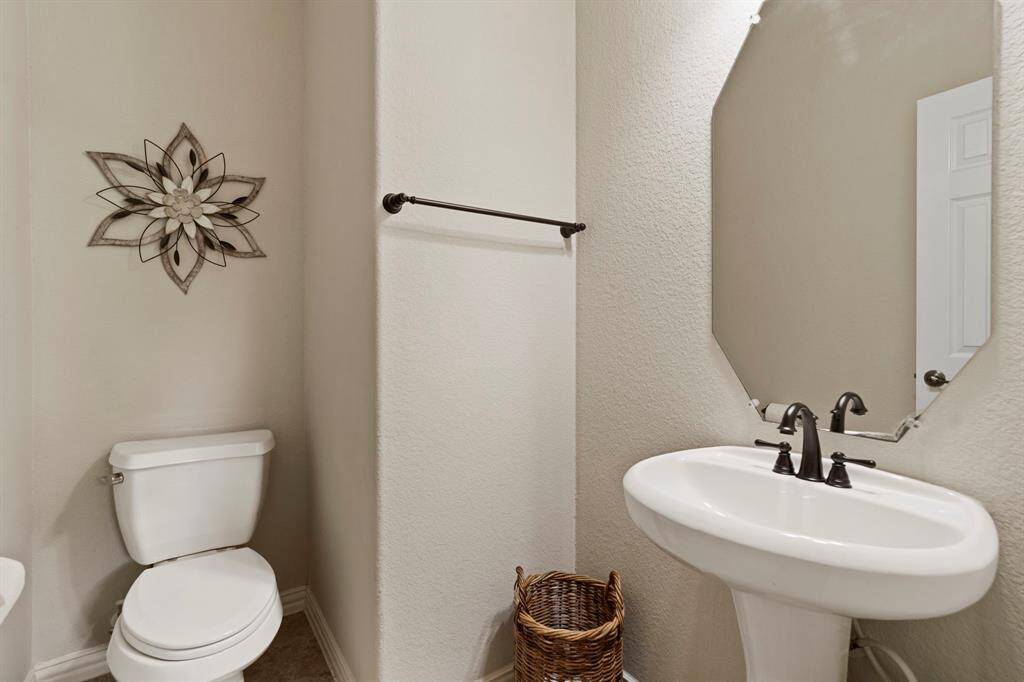 The guest half bath is ideally located near the family room and back patio.