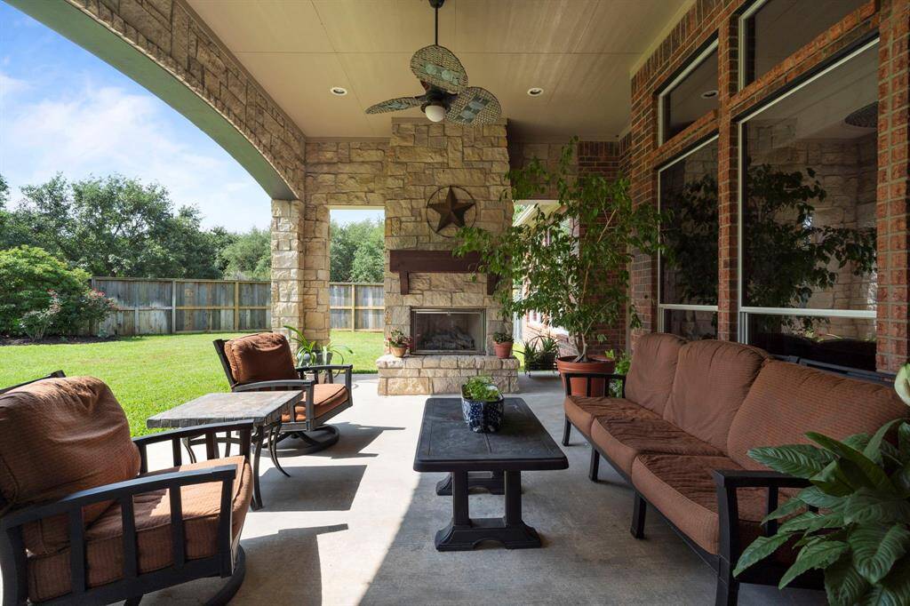 Outdoor living shines with a large covered patio, outdoor kitchen, and gas log fireplace.