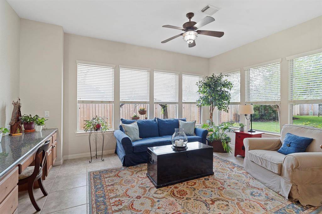 Enjoy the bright and inviting sunroom, surrounded by windows with beautiful backyard views.