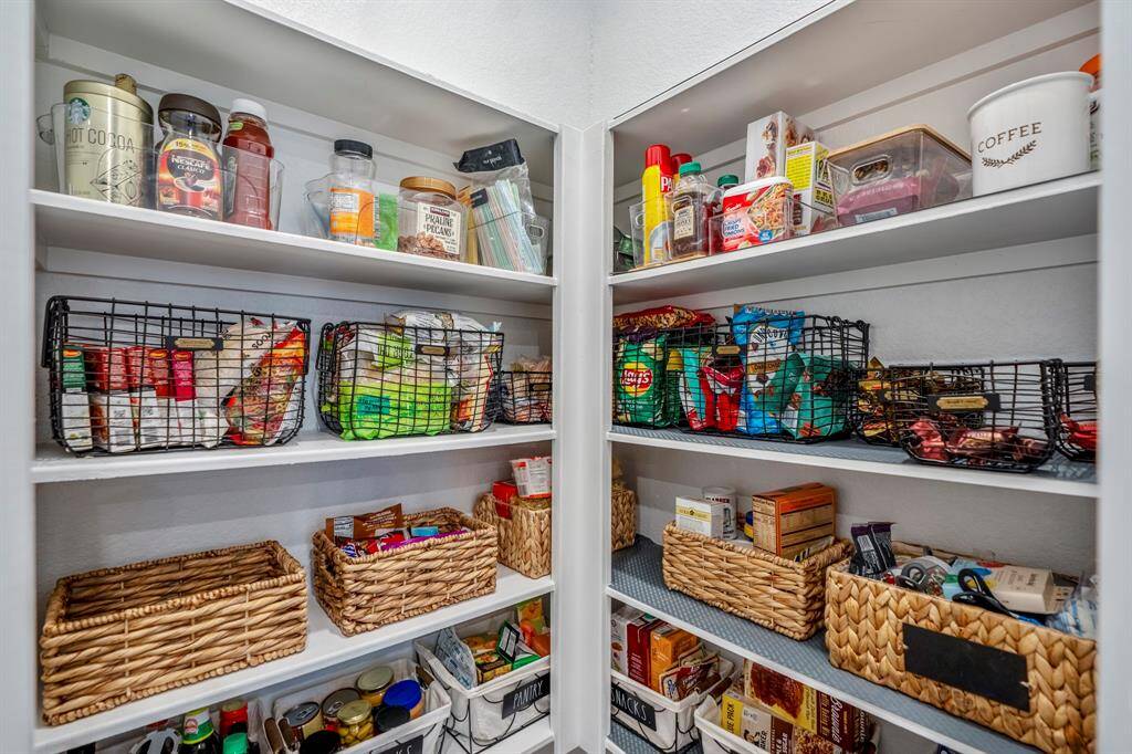 Large walk-in pantry with plenty of storage even above the shelves.