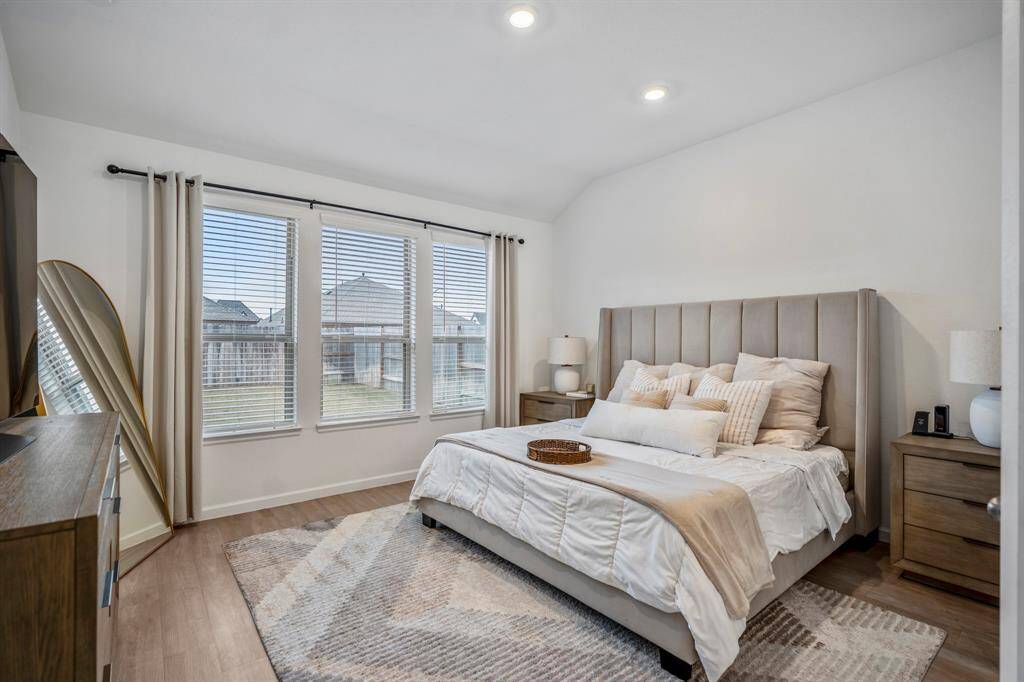 Tucked away in the back of the home overlooking your backyard is this primary bedroom. No carpet here and large enough for a king-sized bed and other large pieces of furniture.