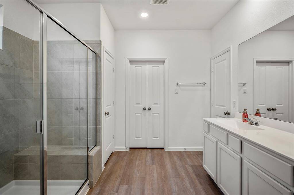 Welcome inside with a stand-up shower featuring a bench and plenty of counter space.