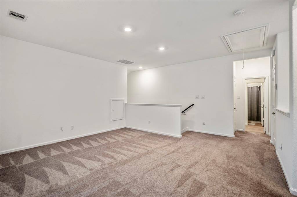At the top of the stairs, this spacious game room with endless possibilities awaits.