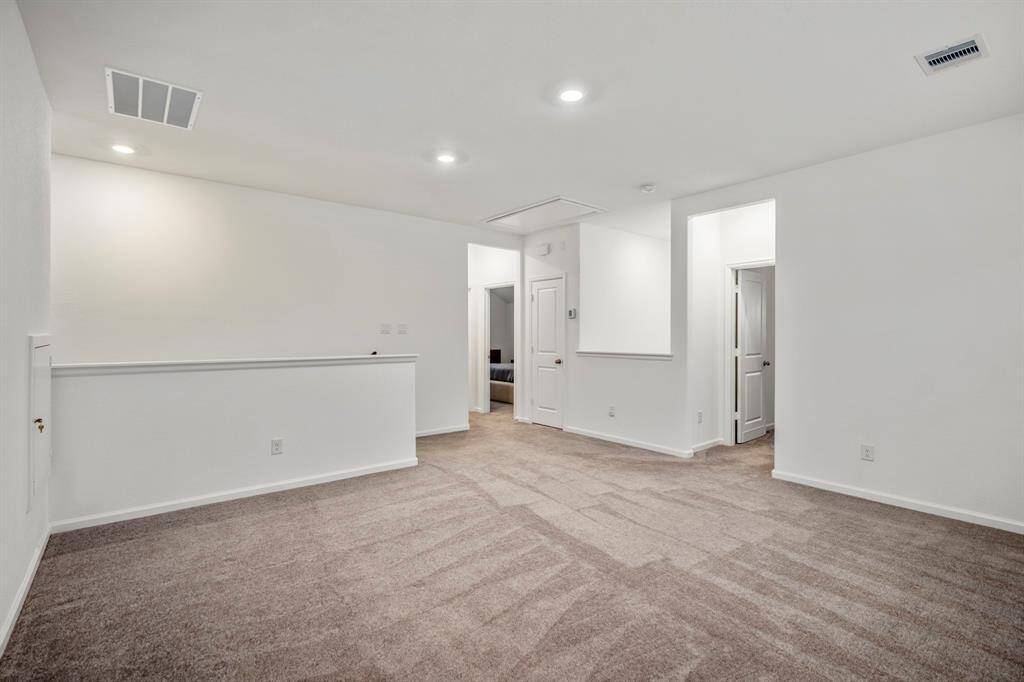 Another view of this spacious game room in relation to the two bedrooms.