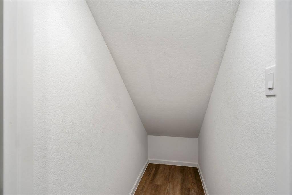 Storage under the stairs in the utility room.