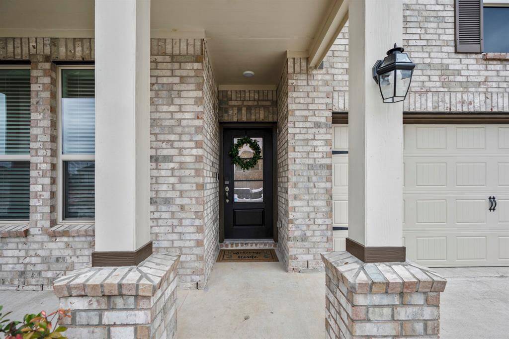 Classic columns at this beautiful covered patio and entry. Front patio can easily fit outdoor furniture for you to enjoy your morning coffee. Let's take you inside.