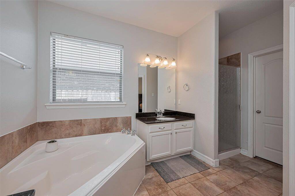 En-suite bathroom with tub and shower