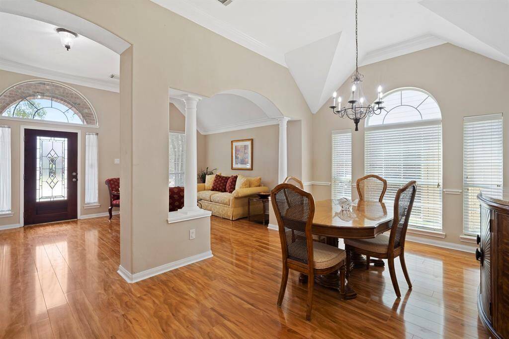 Rich wood flooring adds warmth and sophistication throughout the main living areas, enhancing the home’s timeless charm and cohesive design.