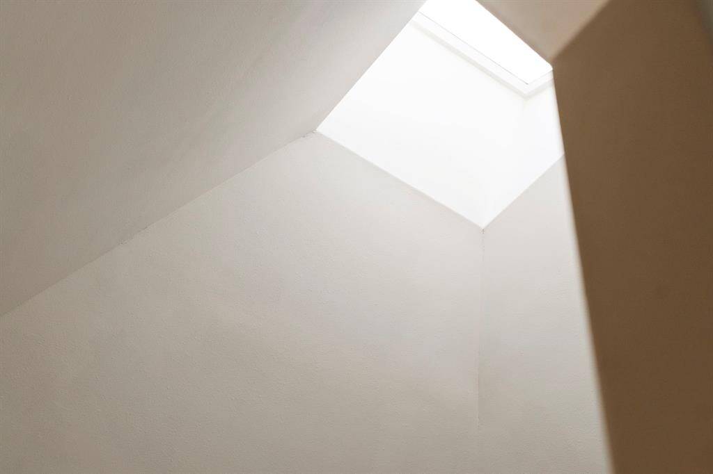 A dramatic skylight brings in an abundance of natural light and enhances the home’s airy feel.
