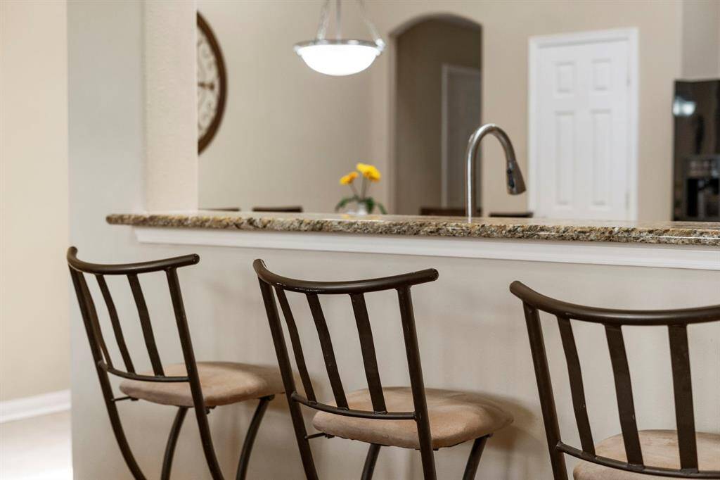 Pull up a barstool and chat with the cook – the breakfast bar adds a casual, cozy vibe to the open-plan family room and kitchen.