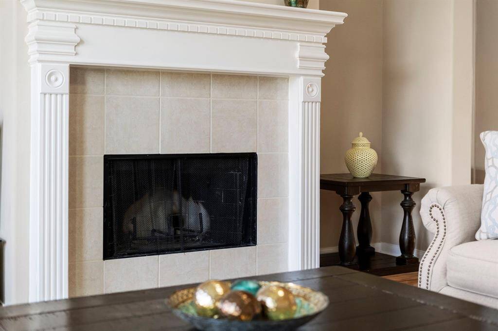 A classic gas-log fireplace creates a cozy focal point in the family room.