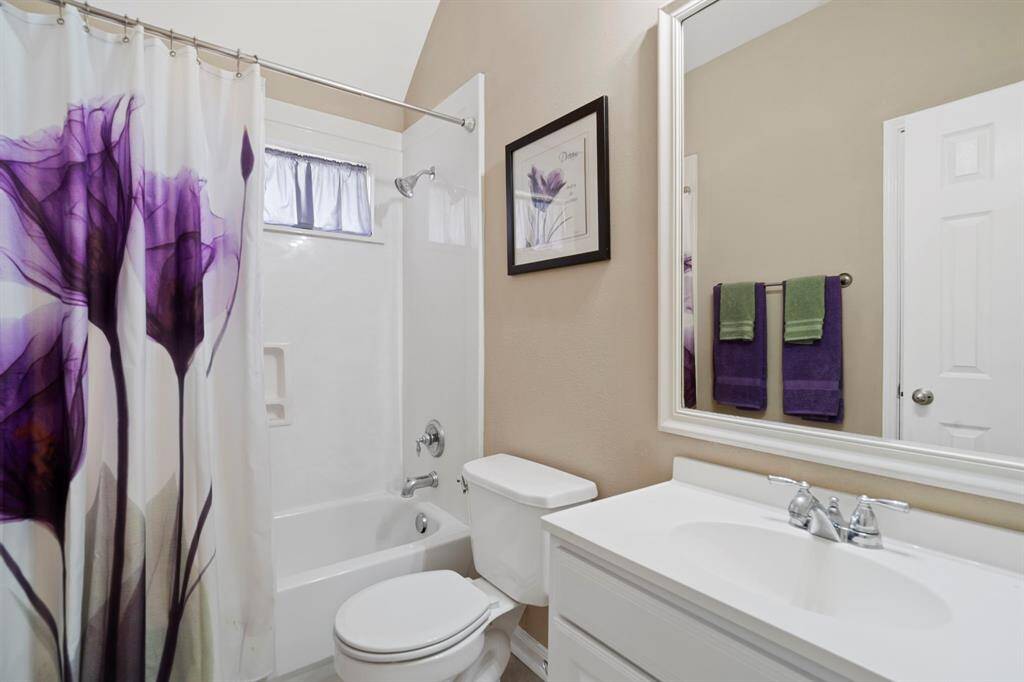 This full bathroom is shared by two bedrooms and features a shower/tub combo and a linen closet.