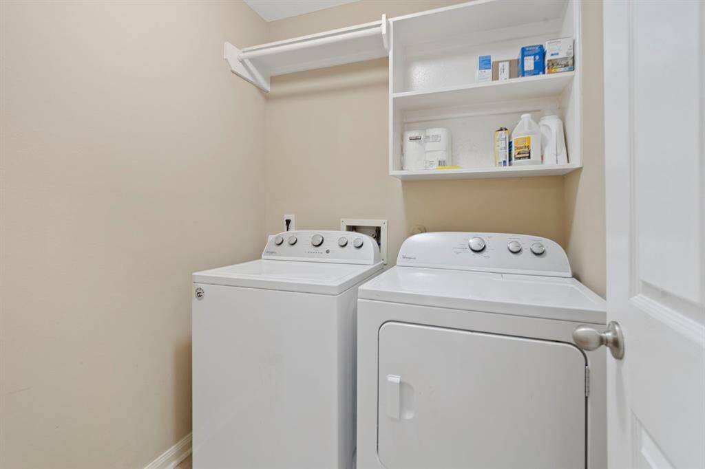 The in-home laundry room is conveniently situated between the attached garage and the bedrooms.