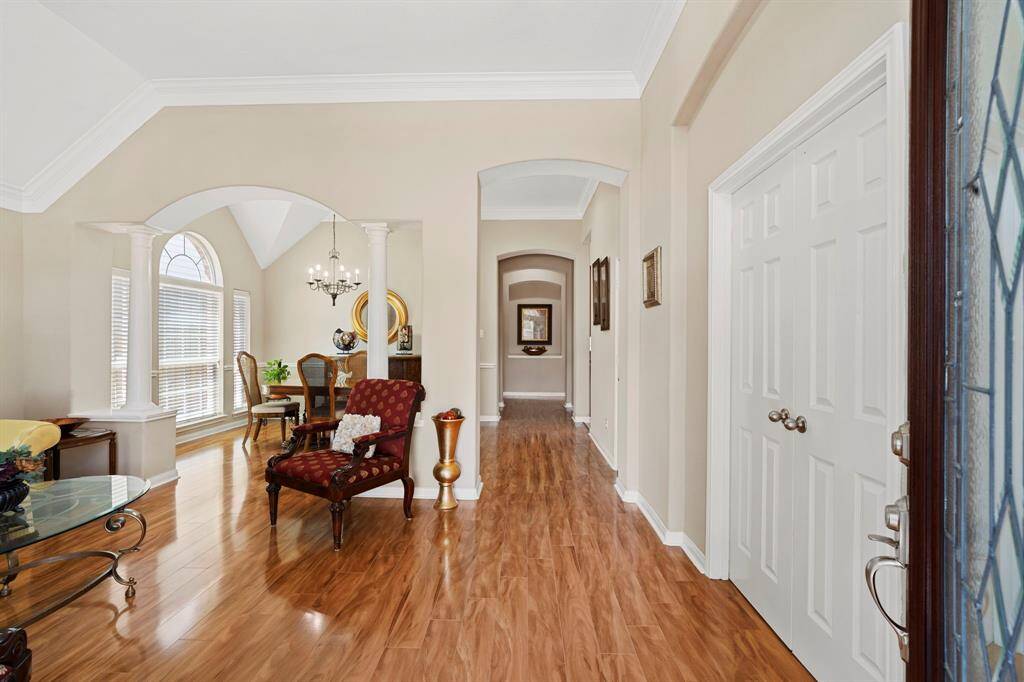 A graceful arched hallway adds architectural interest and a touch of elegance, creating a warm and inviting transition between living spaces.