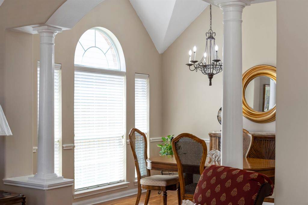 Classic columns subtly define the space between the living and dining rooms, adding architectural character while maintaining an open, connected flow.