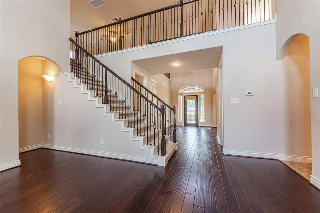 Family room shows off stunning iron baluster staircase