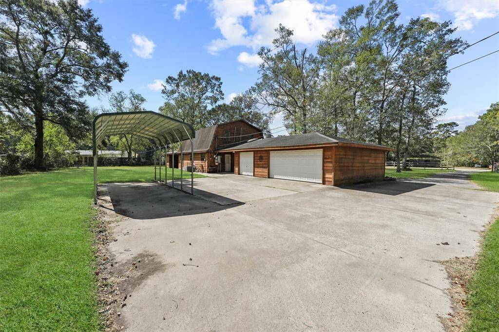 Back of home, showing garage and carport