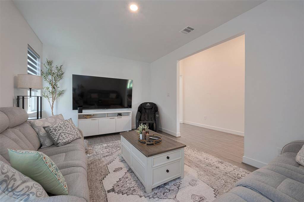Cozy and inviting game room/flex room featuring modern decor, a spacious layout, and abundant natural light, perfect for relaxation and entertainment.