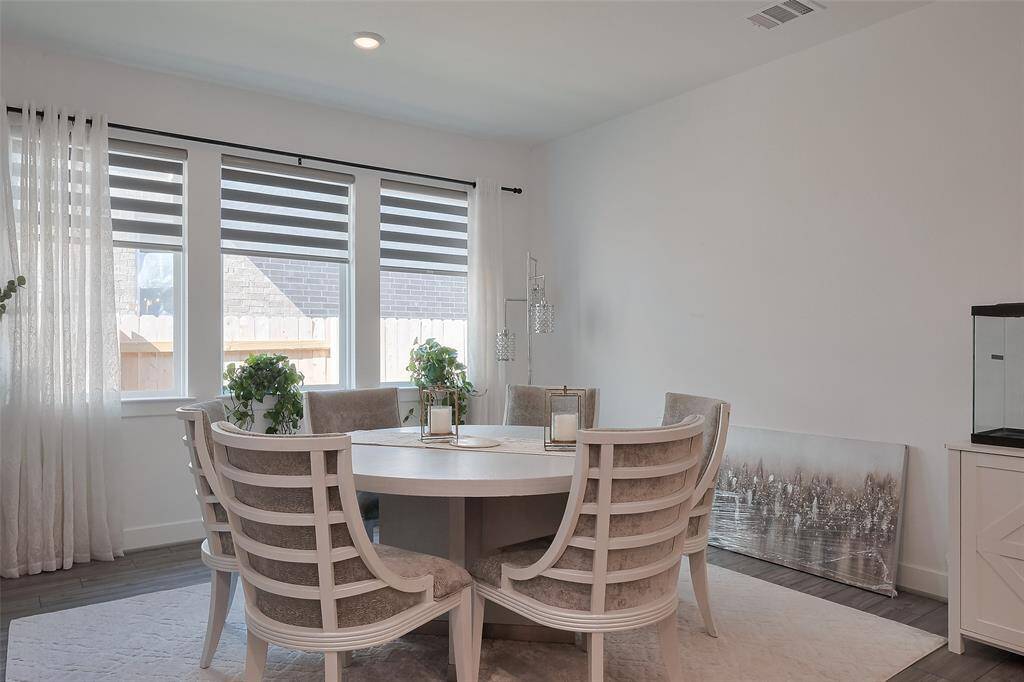 Bright and spacious dining area with large windows, perfect for cozy gatherings.