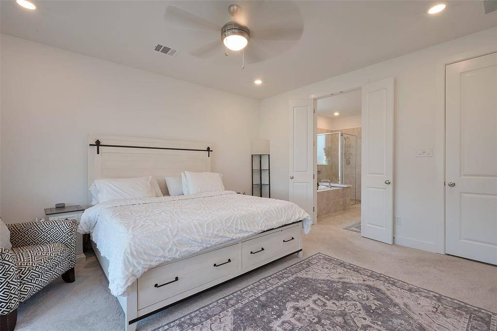 Spacious primary bedroom opens into a modern ensuite bathroom.