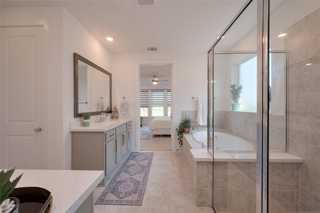 Luxurious primary bathroom featuring elegant dual vanities.