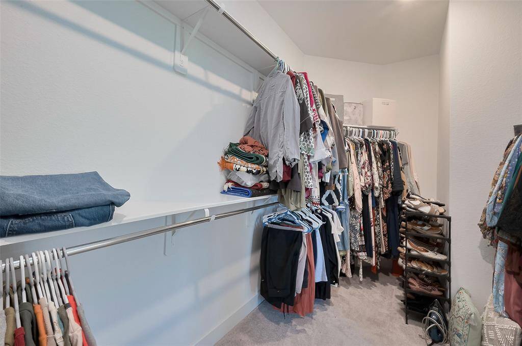Spacious primary walk-in closet with ample storage and organization options.