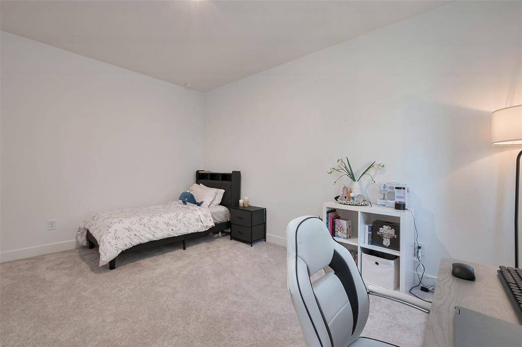 This inviting third bedroom features soft carpeting, ample space, and a cozy atmosphere perfect for relaxation.