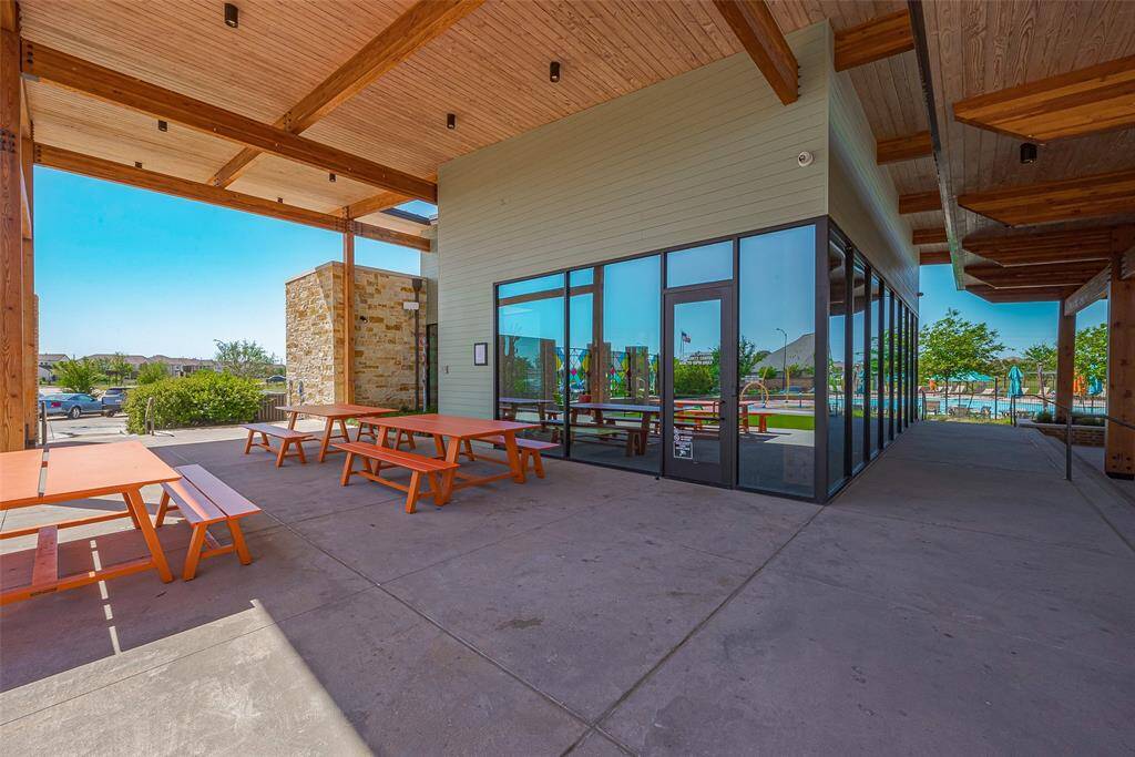 Inviting community clubhouse with modern amenities and outdoor seating, perfect for social gatherings and relaxation.